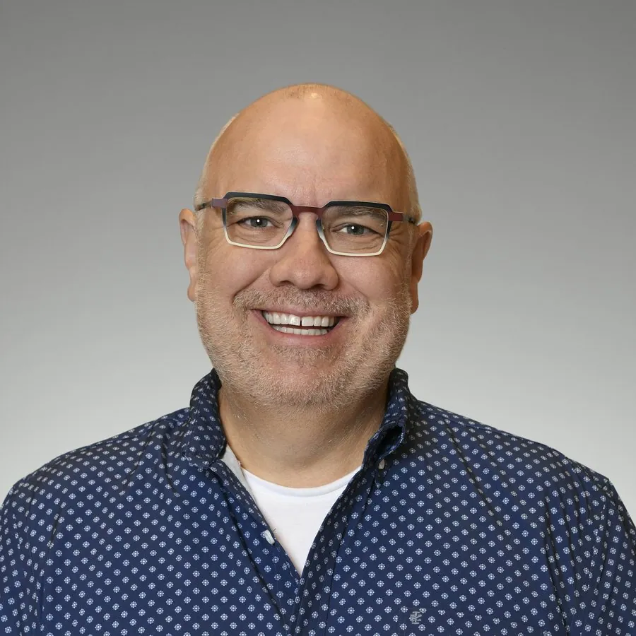 Dr. Ric Crowder, DDS, FAGD, smiling in a white coat